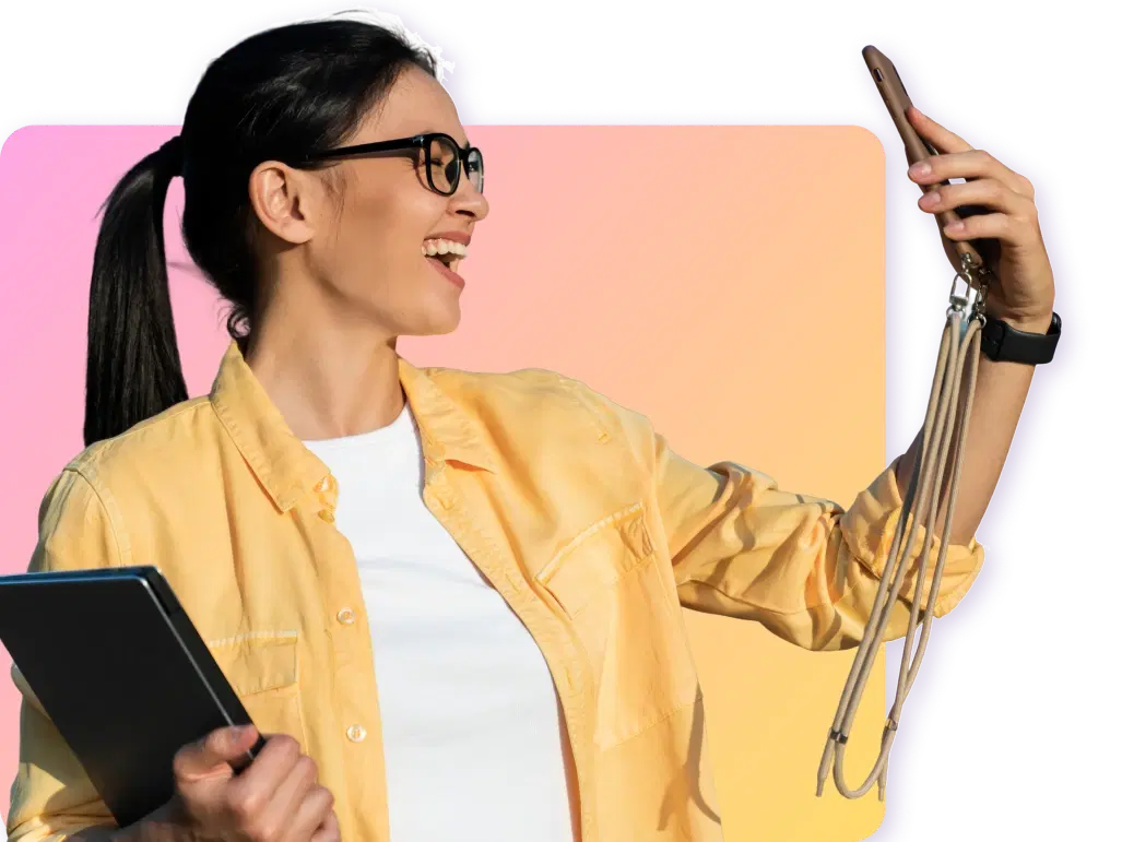 Woman in yellow jacket using smartphone and holding tablet